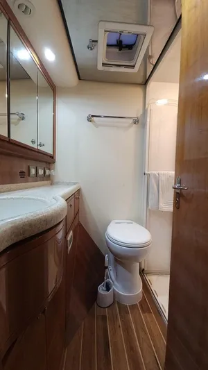 Pecado Yacht Photos Pics 2006 Bertram 510 Convertible yacht bathroom with wood flooring and modern fixtures.