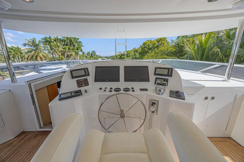 Cerca Trova Yacht Photos Pics Helm of 2011 Westport 112 yacht with modern navigation equipment and tropical backdrop.
