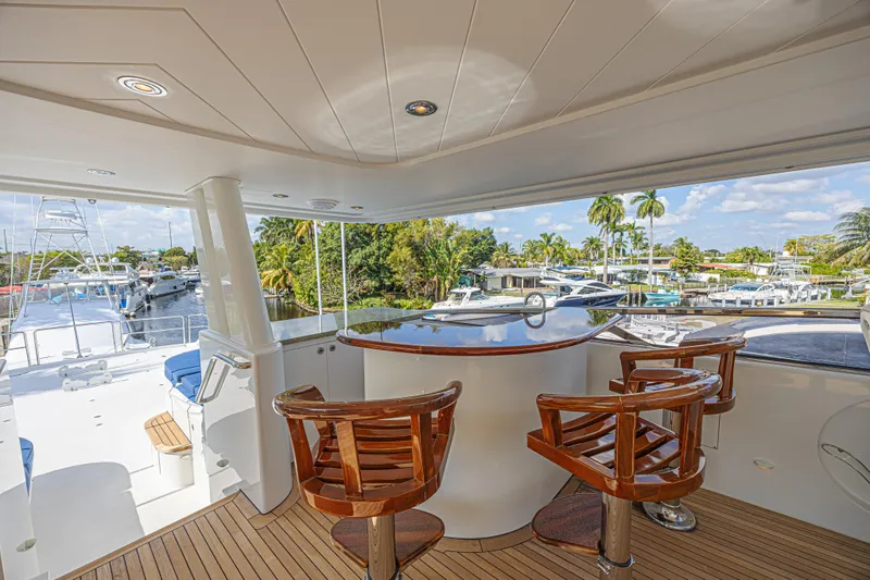 Cerca Trova Yacht Photos Pics Luxurious 2011 Westport 112 yacht deck with bar and wooden chairs, overlooking marina.