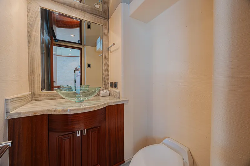 Cerca Trova Yacht Photos Pics Luxurious bathroom on 2011 Westport 112 yacht with glass sink and elegant wood cabinetry.