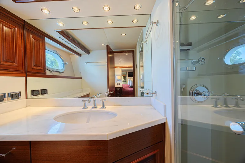 Cerca Trova Yacht Photos Pics Luxurious bathroom interior on 2011 Westport 112 yacht, featuring elegant wood cabinetry and modern fixtures.