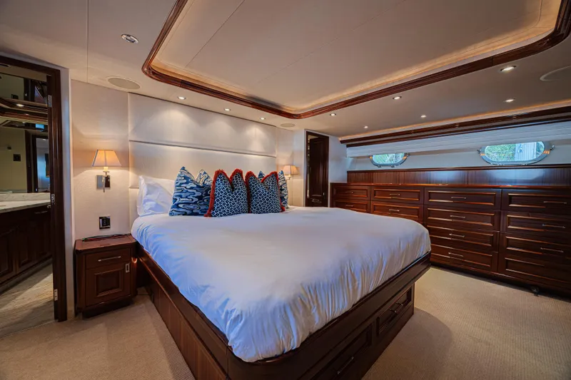 Cerca Trova Yacht Photos Pics Luxurious bedroom interior on a 2011 Westport 112 yacht, featuring elegant wood finishes.
