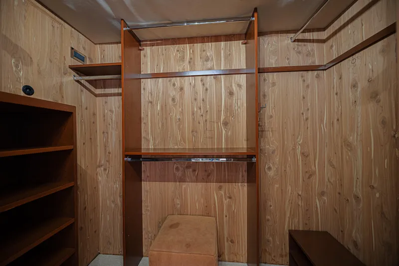 Cerca Trova Yacht Photos Pics Wood-paneled closet with shelves and hanging rods, Westport 112 yacht, 2011 model.