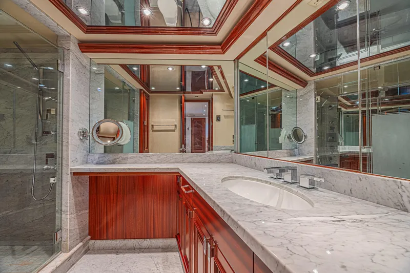 Cerca Trova Yacht Photos Pics Luxurious bathroom with marble countertops and wood accents on a 2011 Westport 112 yacht.