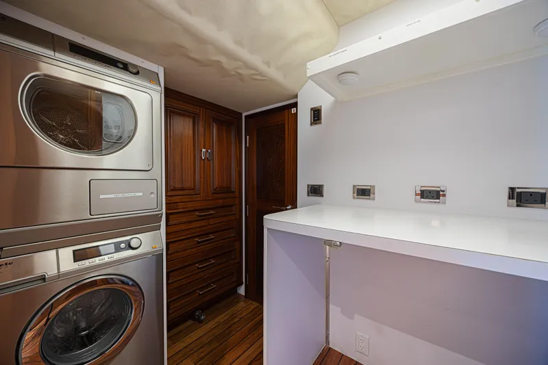 Cerca Trova Yacht Photos Pics Laundry room in a 2011 Westport 112 yacht with stacked washer and dryer.