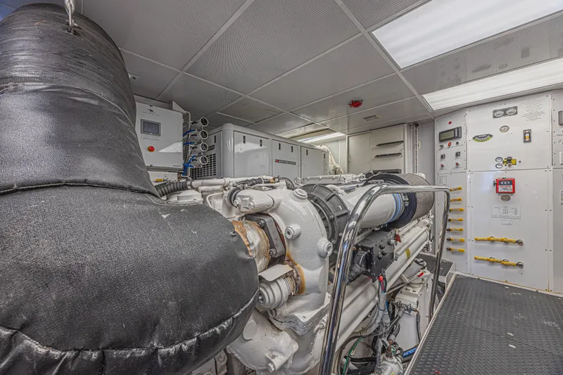 Cerca Trova Yacht Photos Pics Engine room of a 2011 Westport 112 yacht, featuring machinery and control panels.