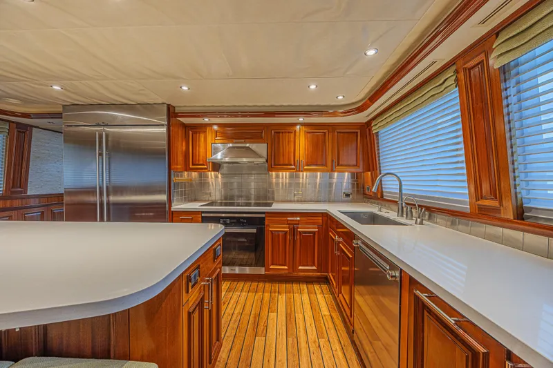 Cerca Trova Yacht Photos Pics Luxurious kitchen interior on 2011 Westport 112 yacht with wood cabinetry and modern appliances.