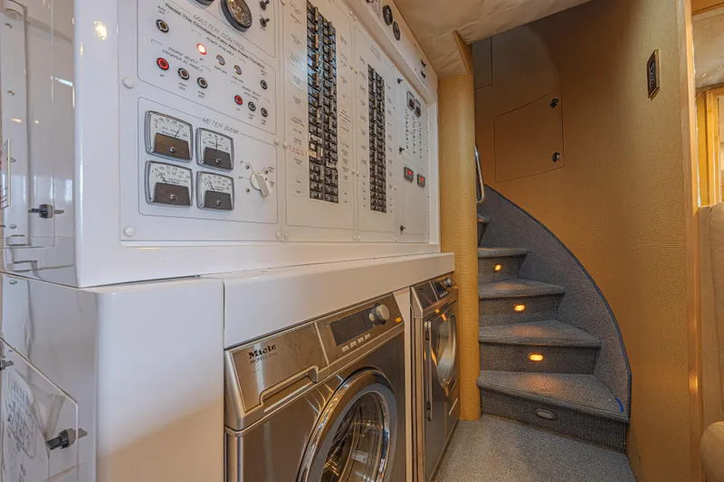 Cerca Trova Yacht Photos Pics Laundry area and control panel on 2011 Westport 112 yacht with spiral staircase.
