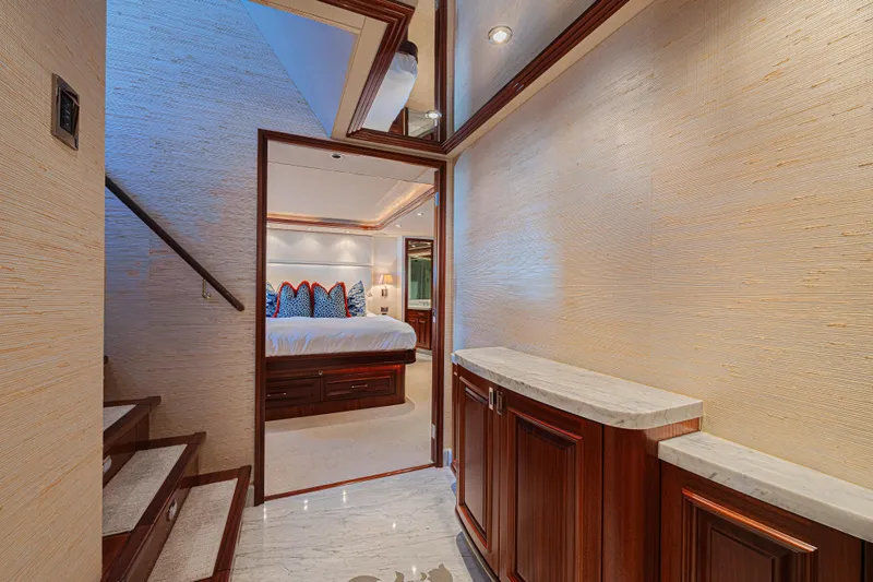 Cerca Trova Yacht Photos Pics Luxurious interior of 2011 Westport 112 yacht featuring elegant bedroom and wooden staircase.