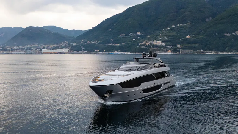 Stile Di Vita Yacht Photos Pics 2023 Riva 102 Super Cosaro yacht cruising in scenic coastal waters.