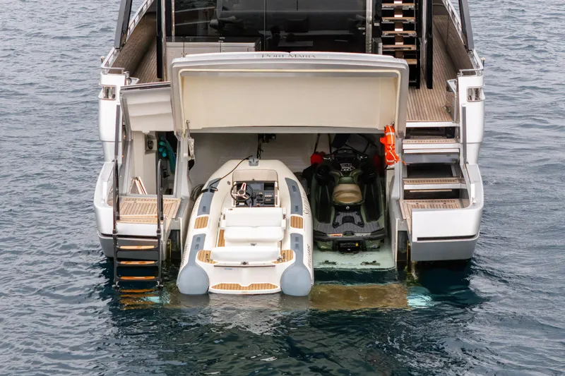 Stile Di Vita Yacht Photos Pics 2023 Riva 102 Super Cosaro yacht with tender and jet ski in rear garage.