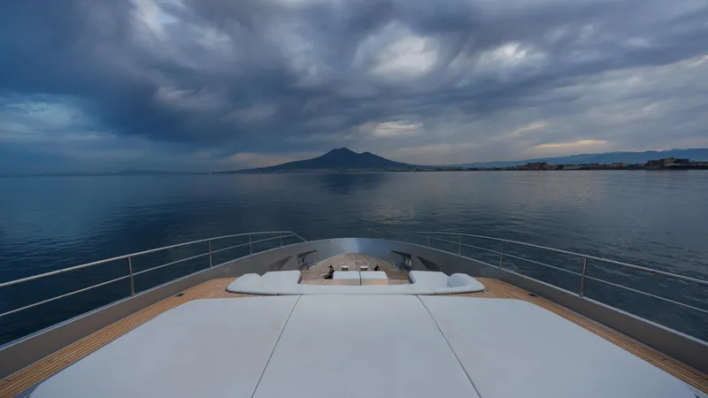 Stile Di Vita Yacht Photos Pics Luxury Riva 102 Super Cosaro yacht, 2023 model, cruising with scenic mountain view.