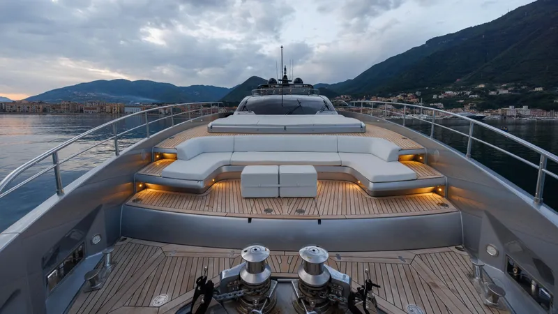 Stile Di Vita Yacht Photos Pics Luxurious 2023 Riva 102 Super Cosaro yacht deck with elegant seating and scenic mountain backdrop.