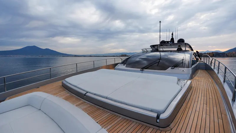 Stile Di Vita Yacht Photos Pics Luxurious 2023 Riva 102 Super Cosaro yacht on calm sea with scenic mountain backdrop.