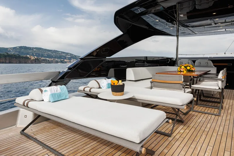 Stile Di Vita Yacht Photos Pics Luxurious deck of 2023 Riva 102 Super Cosaro yacht with sun loungers and dining area.