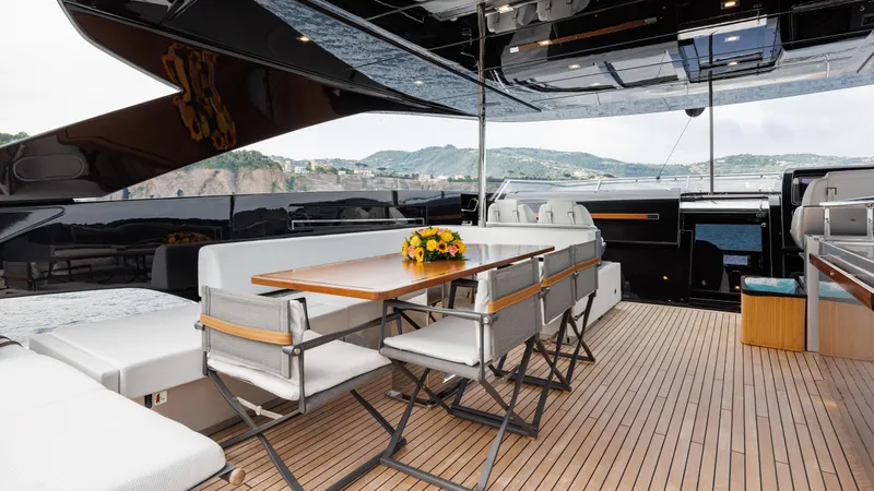 Stile Di Vita Yacht Photos Pics Luxurious 2023 Riva 102 Super Cosaro yacht deck with elegant seating and dining area.