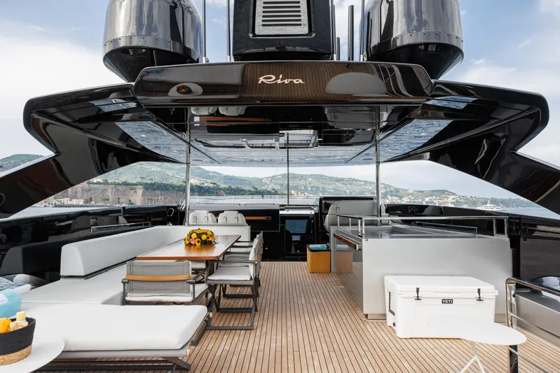 Stile Di Vita Yacht Photos Pics Luxurious 2023 Riva 102 Super Cosaro yacht deck with elegant seating and scenic views.