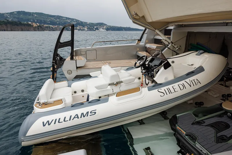 Stile Di Vita Yacht Photos Pics 2023 Riva 102 Super Cosaro yacht with Williams tender in open garage on water.
