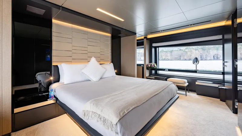 Stile Di Vita Yacht Photos Pics Luxurious bedroom interior of 2023 Riva 102 Super Cosaro yacht with modern design and large windows.
