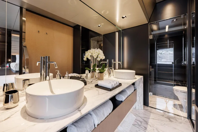 Stile Di Vita Yacht Photos Pics Luxurious bathroom in 2023 Riva 102 Super Cosaro yacht with marble countertops and modern fixtures.