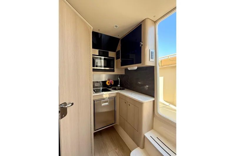 Scout 400lxf Yacht Photos Pics 2024 Scout 400 LXF boat interior kitchen with modern appliances and sleek design.