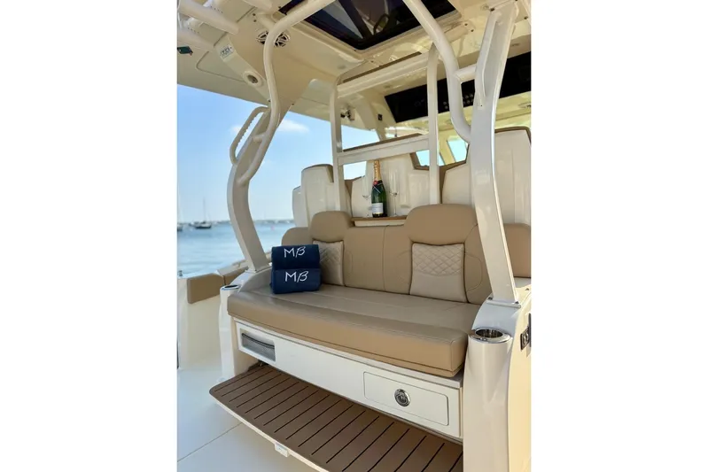 Scout 400lxf Yacht Photos Pics Luxurious seating on 2024 Scout 400 LXF boat with champagne and cushions.