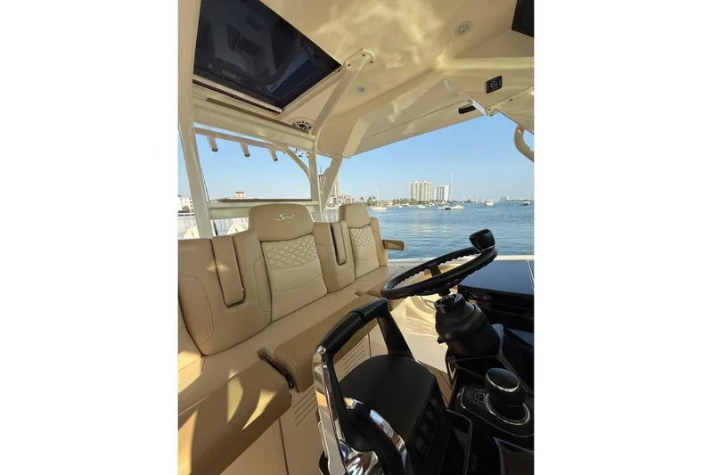 Scout 400lxf Yacht Photos Pics Luxurious interior of 2024 Scout 400 LXF boat with steering wheel and seating.
