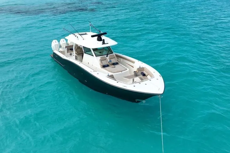 Scout 400lxf Yacht Photos Pics 2024 Scout 400 LXF boat anchored in clear turquoise water.