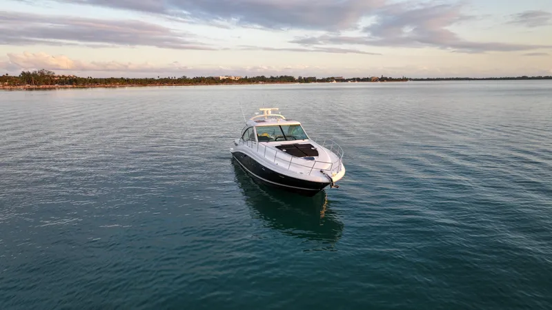  Yacht Photos Pics 2008 Sea Ray 48 Sundancer yacht on calm water at sunset.