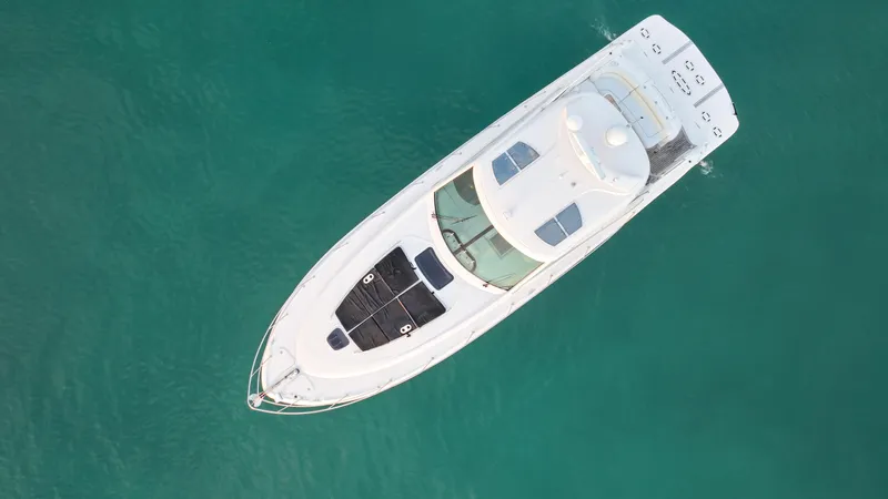  Yacht Photos Pics Aerial view of 2008 Sea Ray 48 Sundancer yacht on turquoise water.