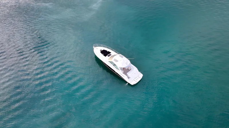  Yacht Photos Pics Aerial view of 2008 Sea Ray 48 Sundancer yacht on turquoise water.