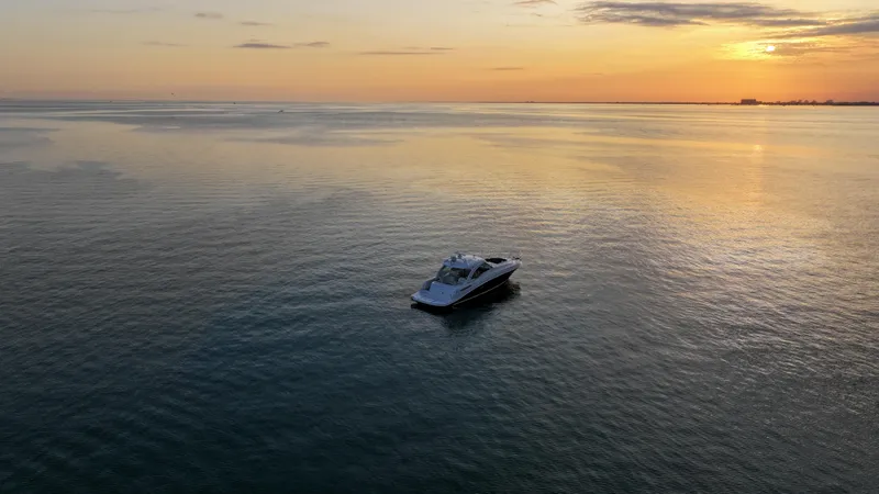  Yacht Photos Pics 2008 Sea Ray 48 Sundancer yacht on calm water at sunset.