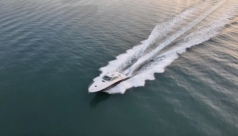  Yacht Photos Pics 2008 Sea Ray 48 Sundancer cruising on open water, leaving a wake behind.