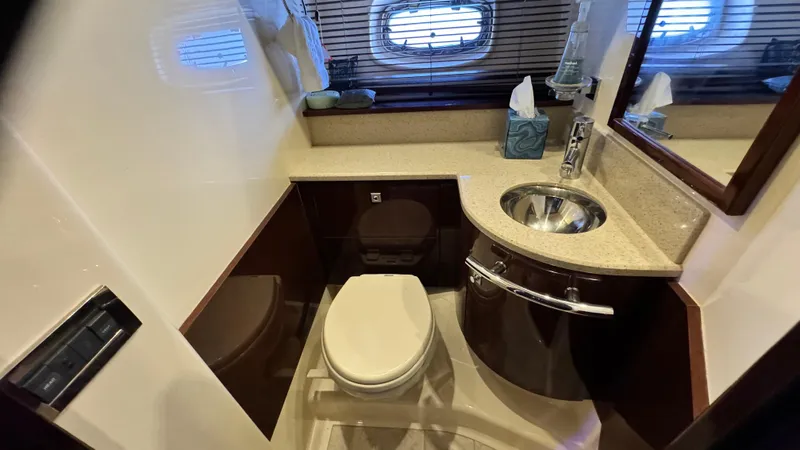  Yacht Photos Pics Luxurious bathroom in 2009 Sea Ray 43 Sundancer yacht with modern fixtures and porthole window.