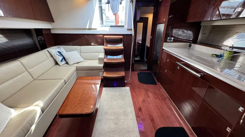  Yacht Photos Pics Luxurious interior of 2009 Sea Ray 43 Sundancer yacht with elegant seating and modern kitchen.