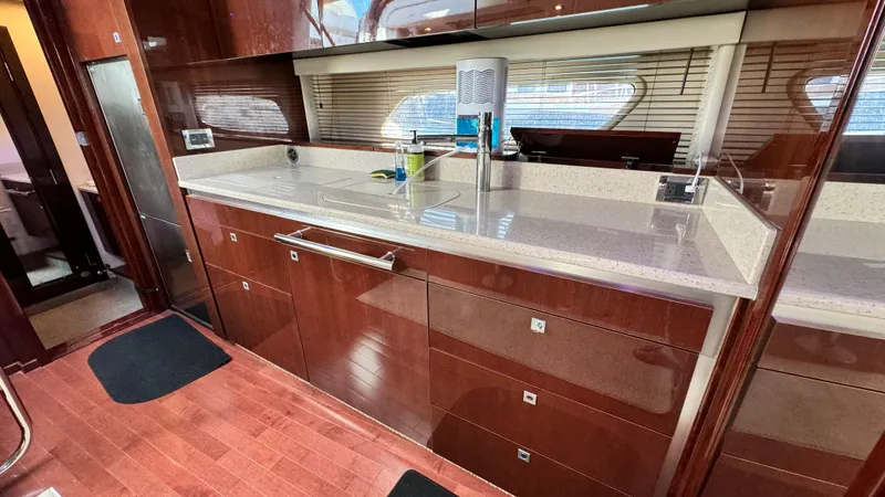  Yacht Photos Pics Luxurious kitchen interior of 2009 Sea Ray 43 Sundancer yacht with sleek cabinetry.
