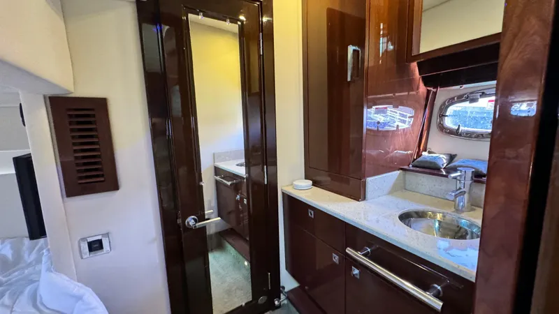  Yacht Photos Pics Luxurious interior of 2009 Sea Ray 43 Sundancer yacht with modern cabinetry and sink.