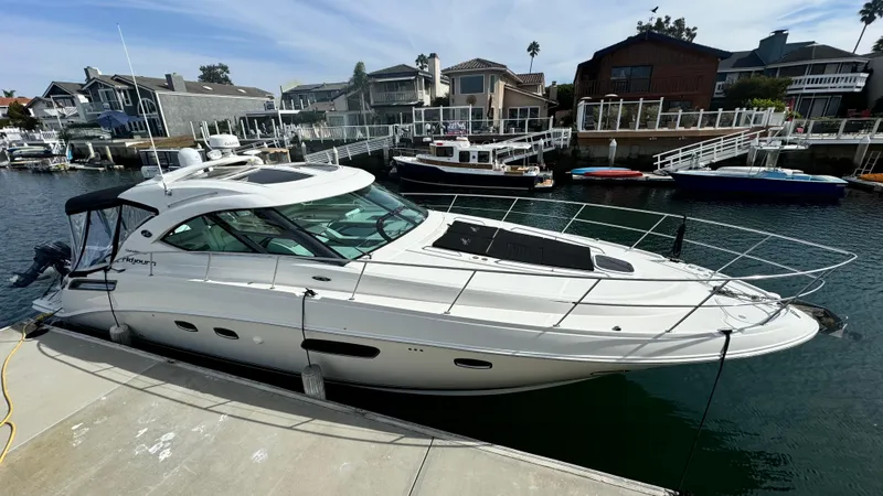  Yacht Photos Pics 2009 Sea Ray 43 Sundancer yacht docked in a marina with waterfront homes.