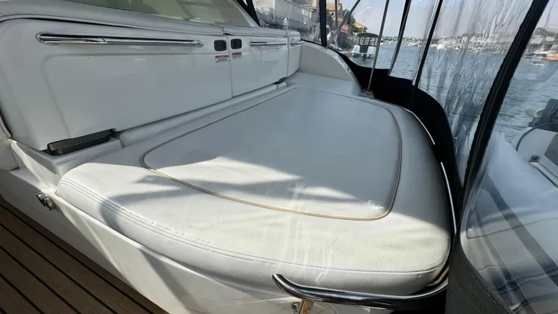  Yacht Photos Pics 2009 Sea Ray 43 Sundancer yacht interior with white seating and marina view.
