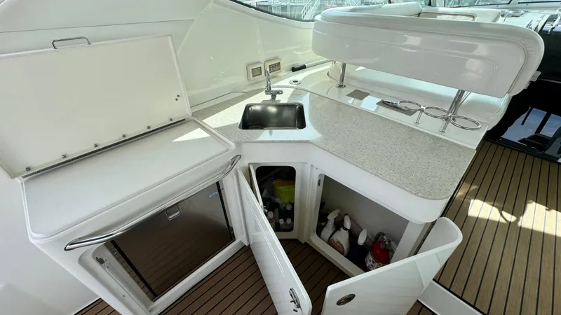  Yacht Photos Pics 2009 Sea Ray 43 Sundancer yacht kitchenette with sink, storage, and countertop.