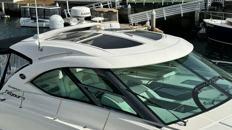  Yacht Photos Pics 2009 Sea Ray 43 Sundancer yacht docked, featuring sleek design and modern amenities.