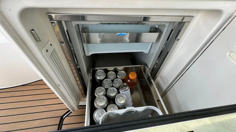  Yacht Photos Pics Mini fridge on 2009 Sea Ray 43 Sundancer, stocked with drinks and honey jar.