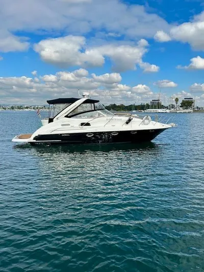Visionary 21 Yacht Photos Pics 2006 Doral Elegante boat on calm water under a partly cloudy sky.