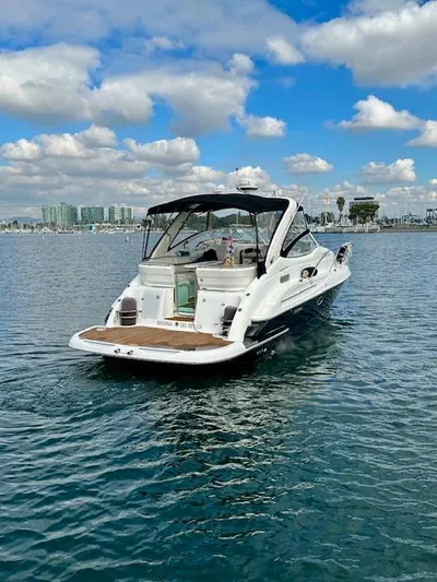 Visionary 21 Yacht Photos Pics 2006 Doral Elegante boat on calm water under a partly cloudy sky.