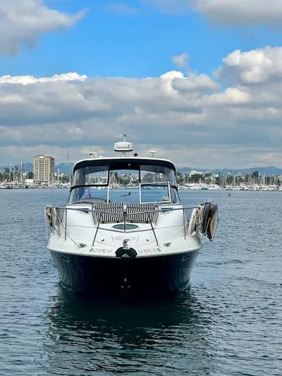 Visionary 21 Yacht Photos Pics 2006 Doral Elegante boat on calm water under a partly cloudy sky.