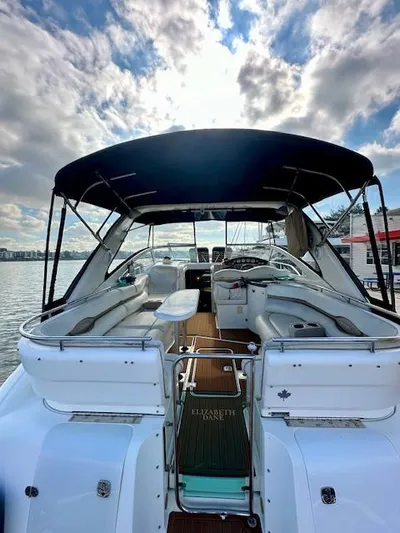 Visionary 21 Yacht Photos Pics 2006 Doral Elegante boat with canopy, docked on a sunny day.
