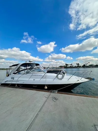 Visionary 21 Yacht Photos Pics 2006 Doral Elegante yacht docked under a bright blue sky with scattered clouds.
