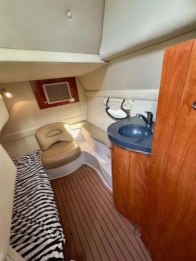 Visionary 21 Yacht Photos Pics 2006 Doral Elegante cabin interior with wood accents, sink, and seating area.