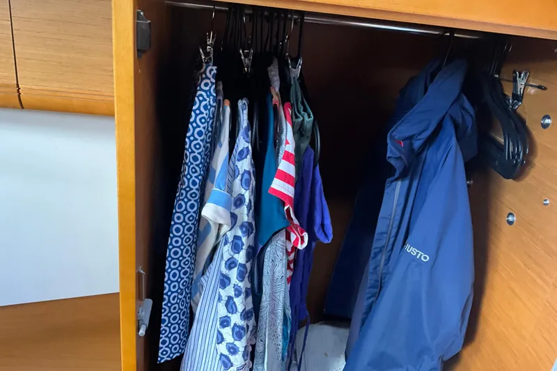 Epicurios Yacht Photos Pics Clothes hanging in a wooden closet on a 2015 Jeanneau Sun Odyssey 469 yacht.