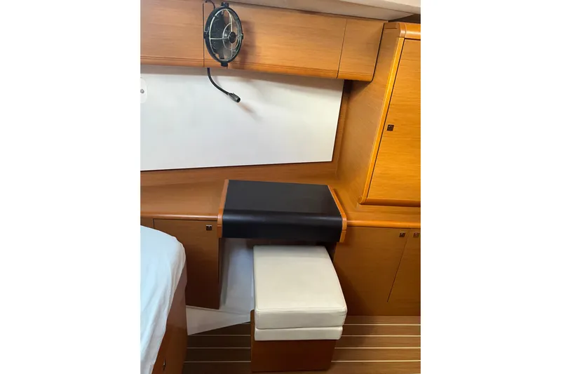 Epicurios Yacht Photos Pics Interior of 2015 Jeanneau Sun Odyssey 469 yacht with wooden cabinetry and seating.